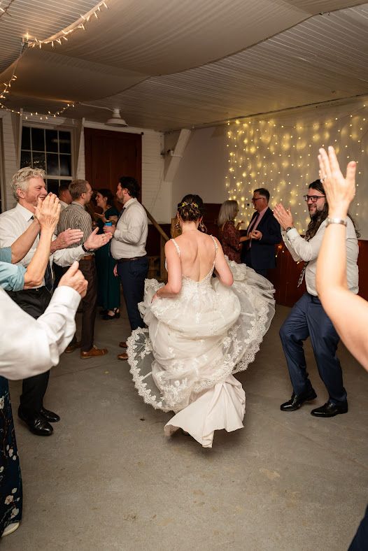 Bride spinning on the dance floor at a barn wedding reception