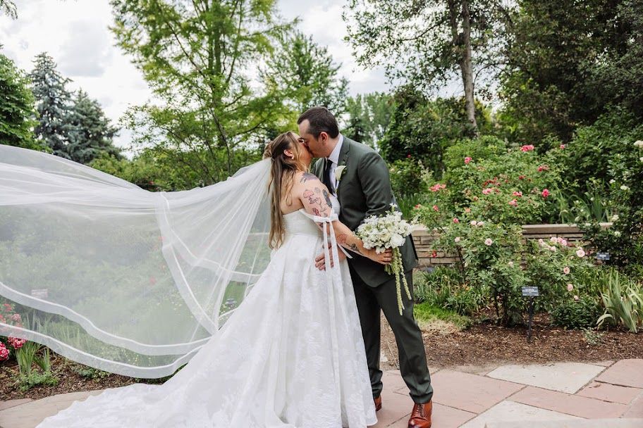 Couple kissing under the veil at a Denver garden wedding